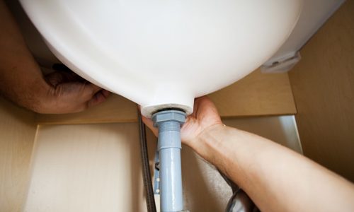 Plumber repairing sink